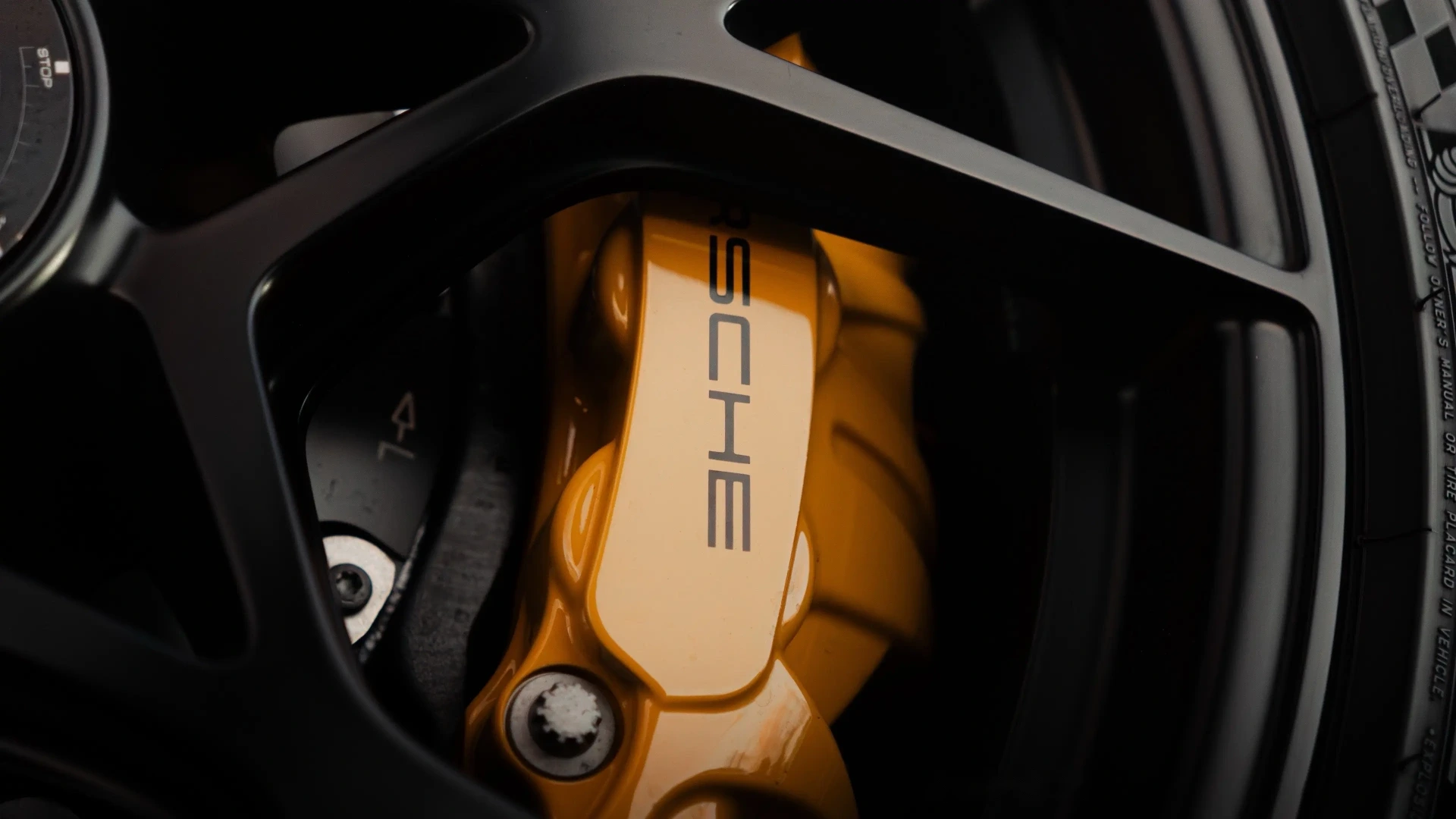 Porsche yellow ceramic brake caliper macro
