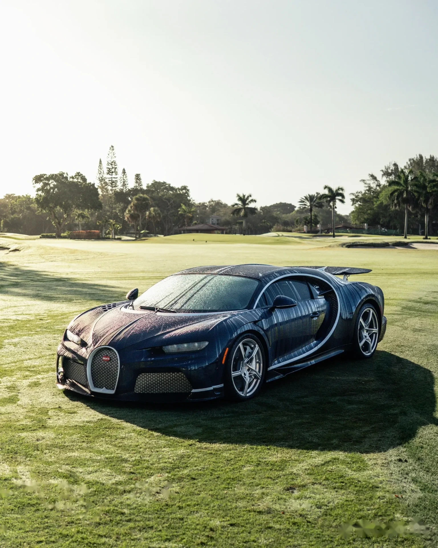 Blue Bugatti Chiron on a manicured golf green